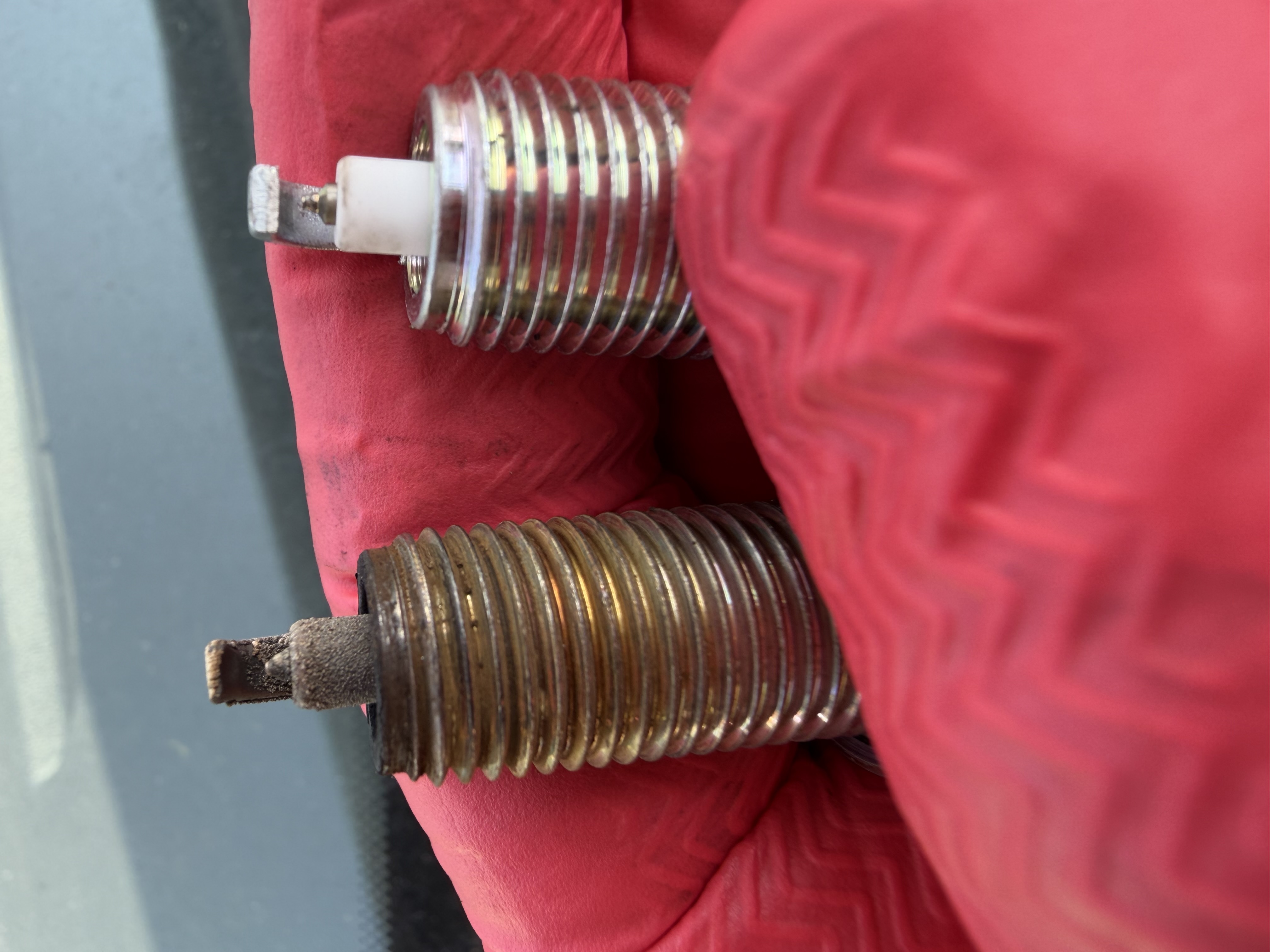 Spark plugs changed during a full car service in Skelmersdale — old vs new comparison